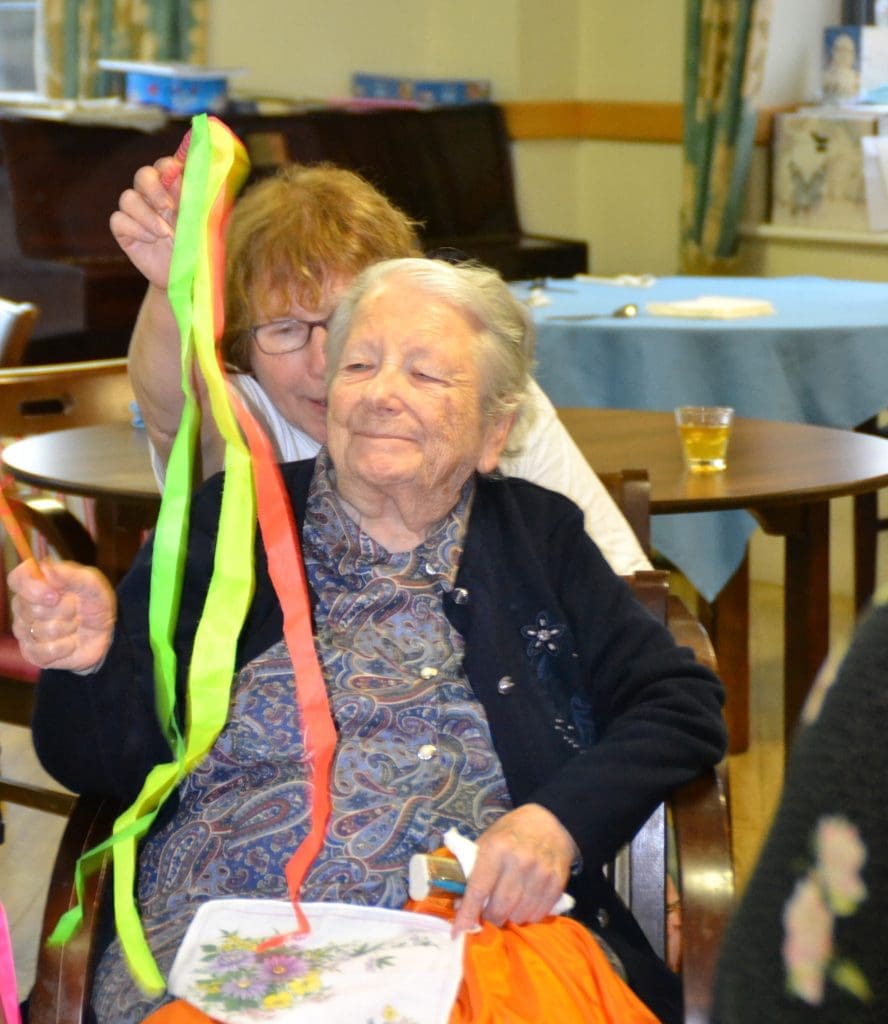 Jewish Care resident with her daughter enjoying the storytelling. 